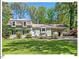 Charming home with a well-manicured lawn and mature trees offering curb appeal and a sense of privacy at 216 Brook Ln, Durham, NC 27712
