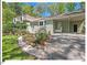 Charming home with a well-manicured lawn, beautiful landscaping and a convenient covered carport at 216 Brook Ln, Durham, NC 27712