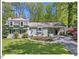 Charming home with a well-manicured lawn, established plantings and a convenient covered carport at 216 Brook Ln, Durham, NC 27712
