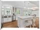 Modern kitchen featuring a stainless steel sink, island with seating, and an abundance of natural light at 216 Brook Ln, Durham, NC 27712