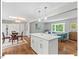 Bright, open floor plan combining the kitchen island with the dining and living room at 216 Brook Ln, Durham, NC 27712