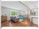 Open concept living room with hardwood floors and large window letting in natural light at 216 Brook Ln, Durham, NC 27712