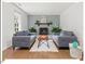 Living room features two sofas, fireplace, and beautiful hardwood floors at 216 Brook Ln, Durham, NC 27712