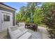 Relaxing back patio with modern seating, an outdoor dining set, and a striped rug at 2634 Turner Pines Dr, New Hill, NC 27562