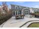 Spacious back patio with an outdoor dining set, modern lounge furniture, and access to a lush backyard at 2634 Turner Pines Dr, New Hill, NC 27562