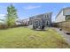 Large backyard with a cozy fire pit area and a spacious patio area with modern seating at 2634 Turner Pines Dr, New Hill, NC 27562