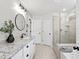 Bright bathroom featuring double sinks, granite countertops, and a glass-enclosed shower at 2634 Turner Pines Dr, New Hill, NC 27562