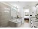 Stylish bathroom with a glass-enclosed shower, soaking tub, and modern gray tiling at 2634 Turner Pines Dr, New Hill, NC 27562