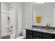 Bright bathroom featuring a shower-tub, dark vanity with granite top, and a large mirror at 2634 Turner Pines Dr, New Hill, NC 27562
