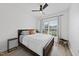 Bright bedroom with a ceiling fan, a wood-framed bed, and a large window overlooking the outdoor view at 2634 Turner Pines Dr, New Hill, NC 27562