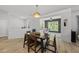 Well-lit dining room boasts an adjacent seating area and attractive modern flooring at 2634 Turner Pines Dr, New Hill, NC 27562