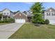 Two-story home with a brick facade, two-car garage, well-manicured lawn, and a charming front porch at 2634 Turner Pines Dr, New Hill, NC 27562