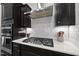 Close-up of kitchen showcasing modern appliances, stylish backsplash, and efficient layout for culinary enthusiasts at 2634 Turner Pines Dr, New Hill, NC 27562