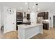 Modern kitchen with stainless steel appliances, sleek countertops, and a central island for cooking and gathering at 2634 Turner Pines Dr, New Hill, NC 27562