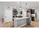 This kitchen features an island, stainless steel appliances, wood flooring, and dark brown cabinets at 2634 Turner Pines Dr, New Hill, NC 27562