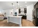 Modern kitchen with stainless steel appliances, sleek countertops, and a central island for cooking and gathering at 2634 Turner Pines Dr, New Hill, NC 27562