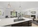 Open-concept kitchen features a large island with sink, seamlessly connecting to the dining and living areas at 2634 Turner Pines Dr, New Hill, NC 27562
