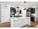 Modern kitchen with stainless steel appliances, sleek countertops, and a central island for cooking and gathering at 2634 Turner Pines Dr, New Hill, NC 27562
