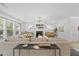 Bright living room features a fireplace, large windows, and modern lighting fixtures at 2634 Turner Pines Dr, New Hill, NC 27562