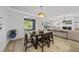 Open-concept living and dining area with neutral color palette and modern light fixture at 2634 Turner Pines Dr, New Hill, NC 27562