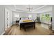 Spacious main bedroom featuring tray ceilings, modern chandelier, and bright, neutral tones at 2634 Turner Pines Dr, New Hill, NC 27562