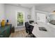 Bright home office with built-in desk area, storage, and view of the backyard at 2634 Turner Pines Dr, New Hill, NC 27562