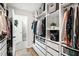 Custom walk-in closet with built-in shelves, drawers, and hanging space, leading to the en suite bath at 2634 Turner Pines Dr, New Hill, NC 27562