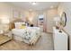 Bright bedroom with floral bedding, desk, and decorative mirror at 265 Sutherland Dr, Franklinton, NC 27525