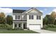 Charming two-story home with a covered front porch and a two-car garage in a residential area at 265 Sutherland Dr, Franklinton, NC 27525