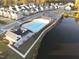 Aerial view of a neighborhood pool, clubhouse, and surrounding homes near a serene lake at 2885 Farmhouse Dr, Apex, NC 27502