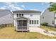 Home exterior view with a screened-in porch, paver patio, and fenced yard at 2885 Farmhouse Dr, Apex, NC 27502
