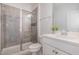 Stylish bathroom features a tiled shower with glass door and modern vanity at 2885 Farmhouse Dr, Apex, NC 27502