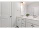 Bathroom boasts dual sinks, a large mirror, and white cabinetry providing storage at 2885 Farmhouse Dr, Apex, NC 27502