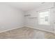 A carpeted bedroom with two floating shelves and a window for natural light at 2885 Farmhouse Dr, Apex, NC 27502