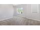 A bright bedroom featuring neutral walls, carpet, and a window providing ample natural light at 2885 Farmhouse Dr, Apex, NC 27502