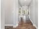 Inviting hallway with hardwood floors leads to open living spaces filled with natural light at 2885 Farmhouse Dr, Apex, NC 27502