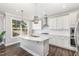 Beautiful white kitchen with a large island, stainless steel appliances, pendant lights, and ample counter space at 2885 Farmhouse Dr, Apex, NC 27502