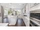 Stylish kitchen with stainless steel appliances, a center island with a sink, gas range and a view to the backyard at 2885 Farmhouse Dr, Apex, NC 27502