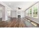 Bright living room with a fireplace, many large windows, wood floors and neutral colored walls at 2885 Farmhouse Dr, Apex, NC 27502