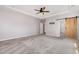 Expansive main bedroom with a ceiling fan and sliding barn door at 2885 Farmhouse Dr, Apex, NC 27502