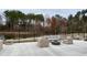 Outdoor patio with comfortable seating, a modern fire pit, and serene lake views at 2885 Farmhouse Dr, Apex, NC 27502