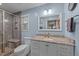Bathroom with granite countertops, wooden shower with seating, and updated fixtures at 300 Plantation Rd, Clayton, NC 27520