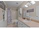 Bathroom features a shower and tub combo, a vanity sink with countertop space, and modern lighting at 300 Plantation Rd, Clayton, NC 27520
