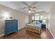 Bedroom with neutral walls, wood-look floors, a ceiling fan, and large windows for natural light at 300 Plantation Rd, Clayton, NC 27520