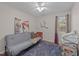 Bedroom with hardwood floors, ceiling fan, and a cozy couch beneath a window at 300 Plantation Rd, Clayton, NC 27520