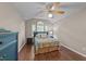 Bedroom features vaulted ceilings, wood-look floors, a ceiling fan, and natural lighting at 300 Plantation Rd, Clayton, NC 27520