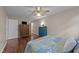 Bedroom offers wood-look floors, neutral paint, a ceiling fan, and an accent chest at 300 Plantation Rd, Clayton, NC 27520