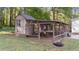 Exterior view of a large walk-in chicken coop, with chickens, attached to another structure at 300 Plantation Rd, Clayton, NC 27520