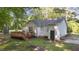 Rear exterior with a new deck, neutral siding, dark roof, and door with green backyard space at 300 Plantation Rd, Clayton, NC 27520