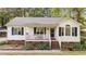 Charming single-story home with a cozy front porch and well-maintained landscaping in a quiet neighborhood at 300 Plantation Rd, Clayton, NC 27520